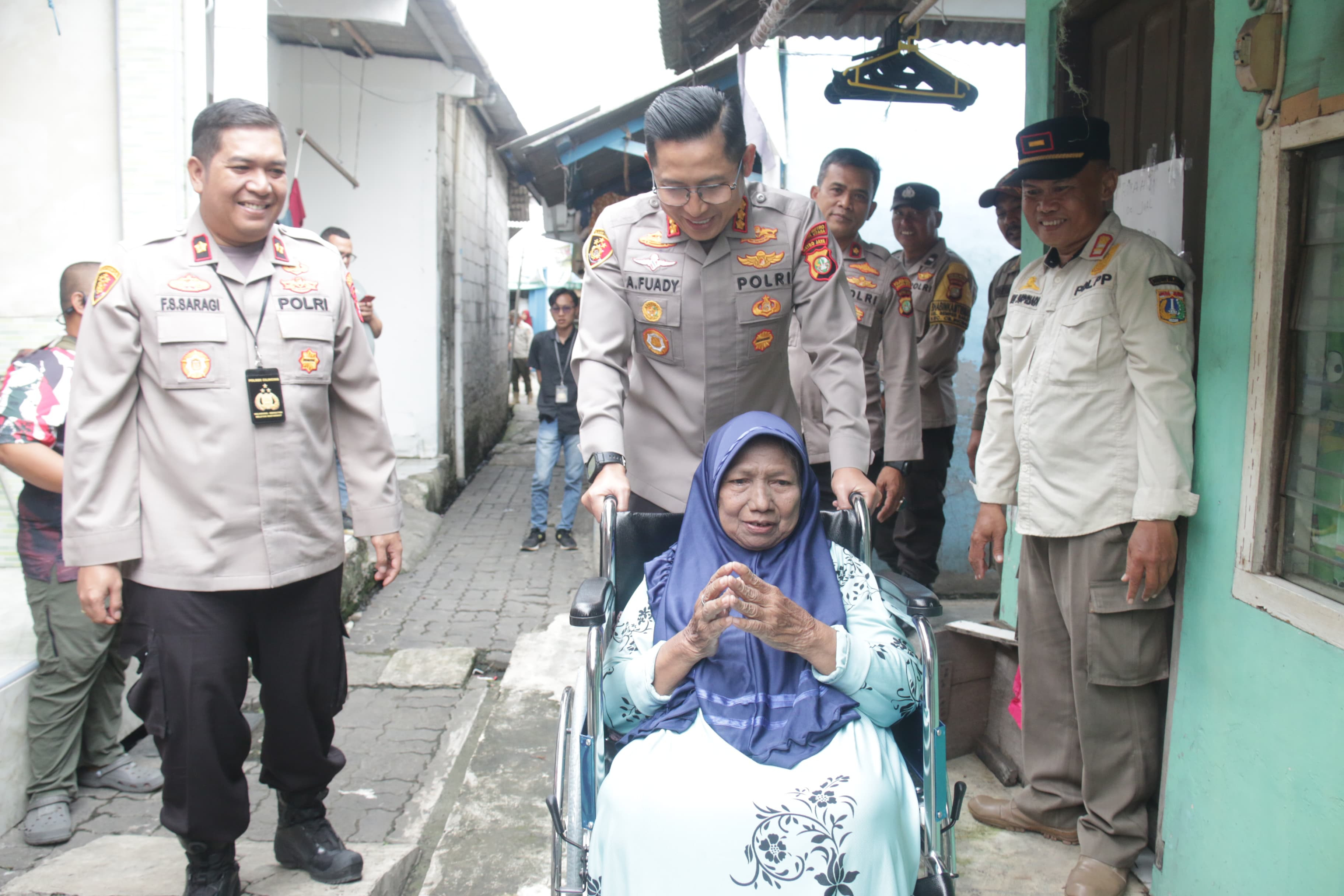Kapolres Metro Jakarta Utara Berikan Kursi Roda Untuk Lansia Terdampak Banjir di Cilincing